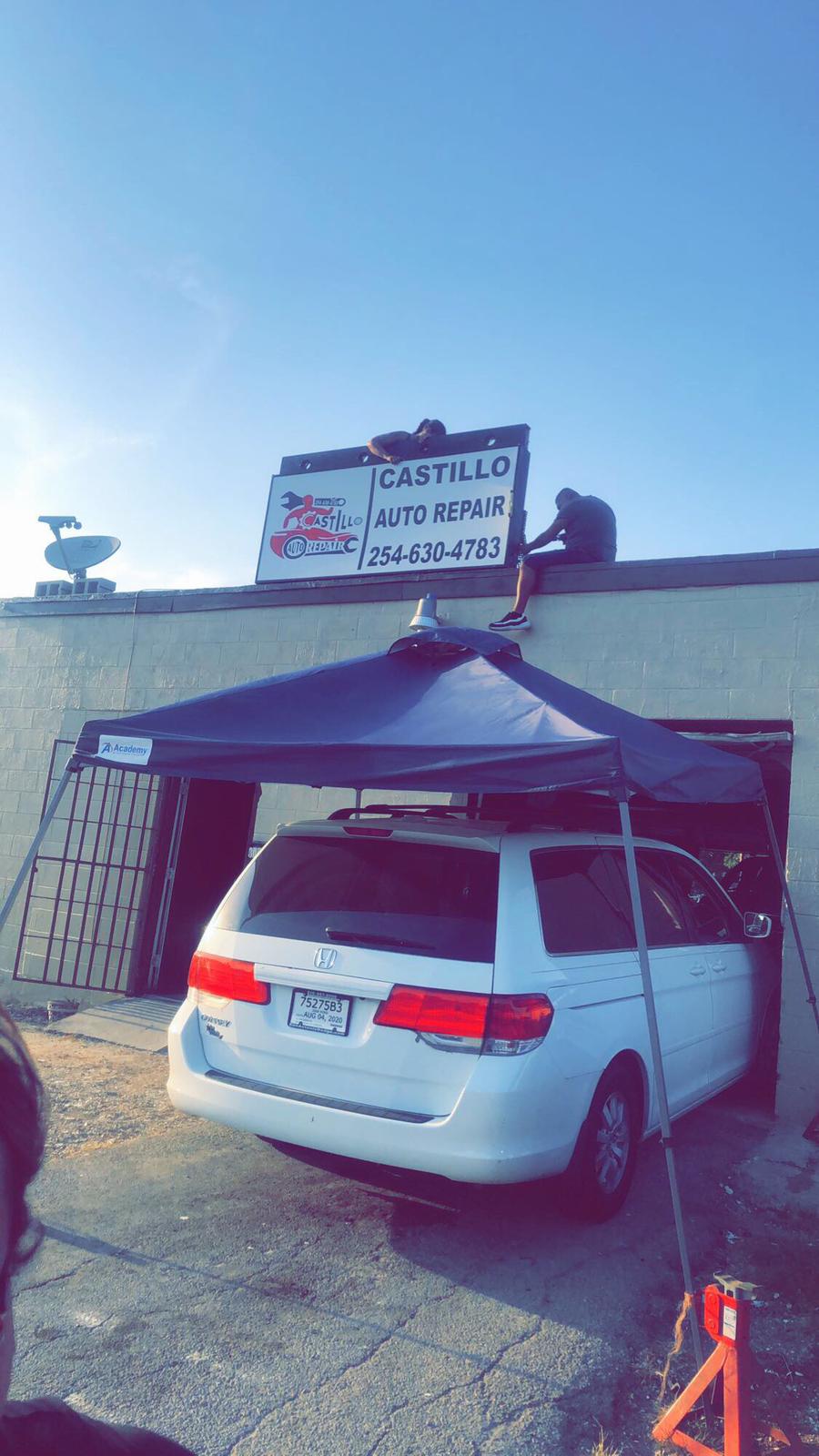 Cars on lift inside Castillo Auto Repair bay
